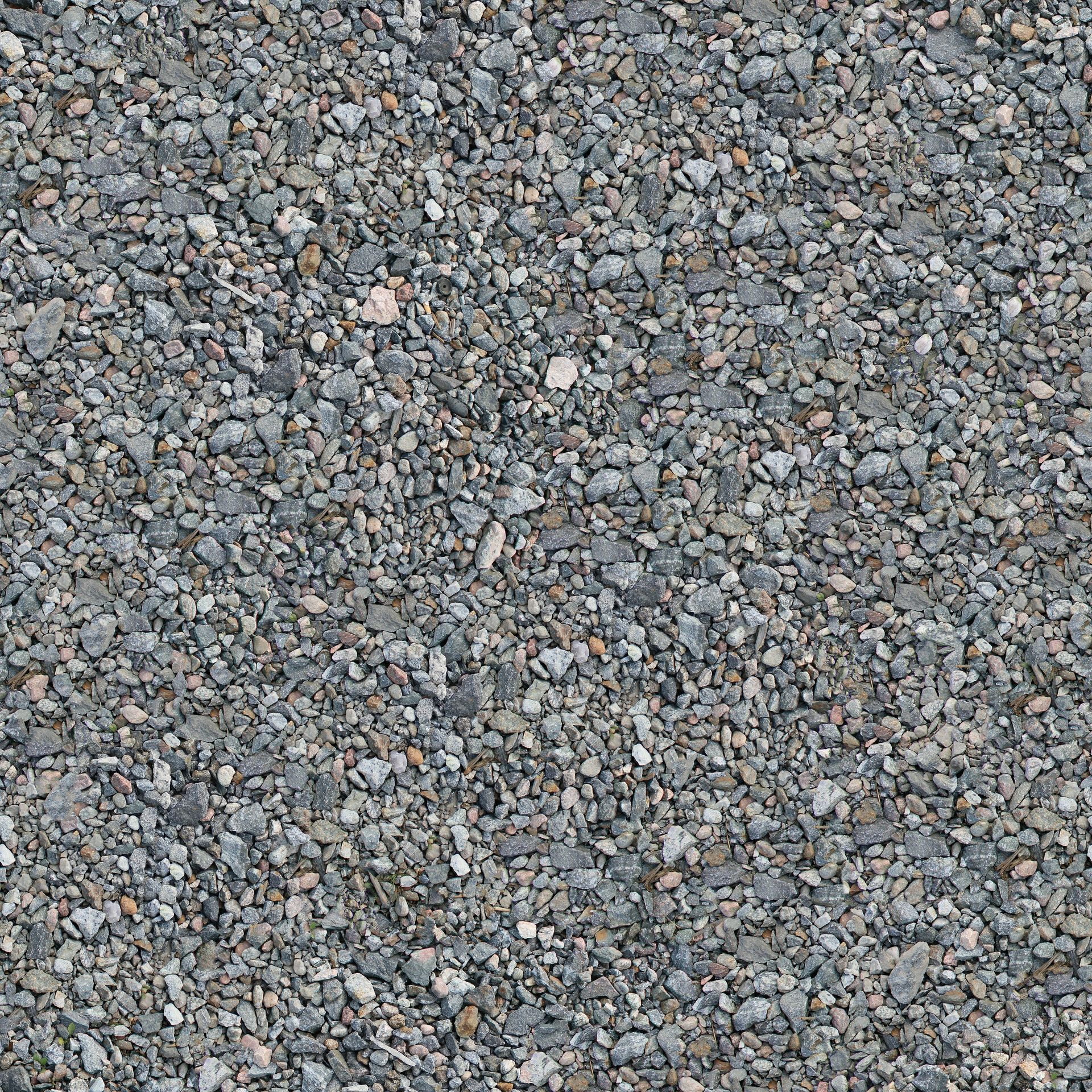 Detailed view of a gravel surface showing texture and pattern of small pebbles and stones.
